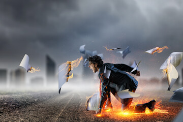 Wall Mural - Determined businessman leaving fire trails on asphalt