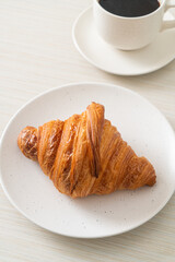 fresh croissant on white plate