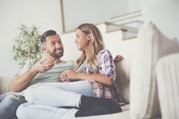 Wall Mural - loving couple relaxing on the couch on a free evening