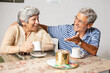 © gajendra - Happy indian senior couple enjoy cup of tea or coffee laughing and talking, Retired old husband wife spend time together at home., Aging. Stress free. Relationship bonding,
