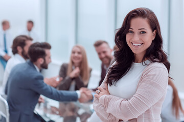 close up. smiling young business woman standing in office