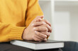 Pray and religion concept, Female christian hands folded on holy bible and praying to god.