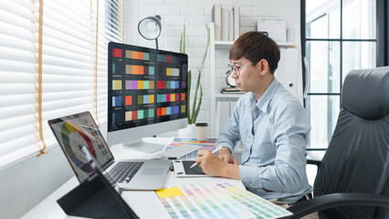 Wall Mural - creativity concept, male graphic designer using tablet and looking color swatch samples on screen