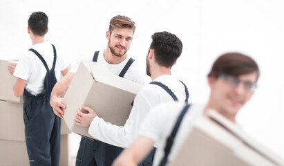 Portrait of movers holding box smiling isolated on white backgro