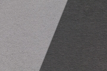 Texture of craft gray and black paper background, half two colors, macro. Structure of vintage craft grey cardboard.