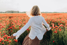 Woman Dancing In Poppy Field
