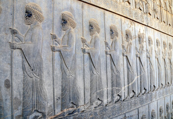 Wall Mural - Ancient wall with bas-relief with assyrian warriors with spears, Persepolis, Iran