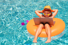 Little Businessman Working On Tropical Beach. Summer Business. Child Remote Working On Laptop In Pool. Little Business Man Working Online On Laptop In Summer Swimming Pool Water.
