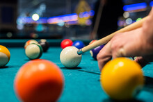 Billiard Balls On The Pool Table With Player's Hands And Stick.