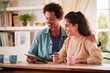 © Monkey Business - Couple With Credit Card At Home Use Digital Tablet To Review Finances For Starting Business