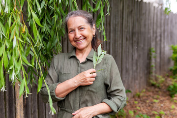 Poster -   60-year-old woman in   green dress outdoors in summer.