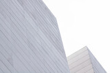 Fototapeta  - Abstract contemporary office building. Modern white building facade close up on clear day.