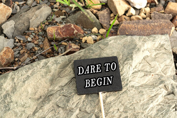 Wall Mural - Motivational quote on a chalkboard with stone beach background