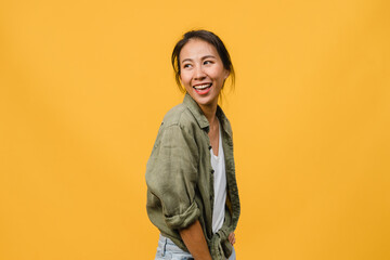 Wall Mural - Portrait of young Asia lady with positive expression, smile broadly, dressed in casual clothing over yellow background. Happy adorable glad woman rejoices success. Facial expression concept.