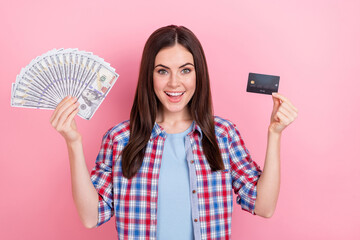 Sticker - Photo of charming positive young female prefer plastic card over cash money isolated on pink color background