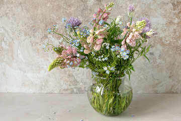 Wall Mural - vase with pink lupins on a light background