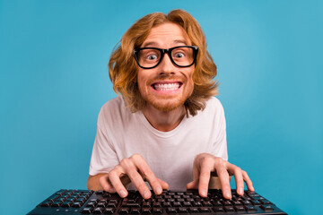 Canvas Print - Photo of cheerful excited man toothy smile write keyboard coworking isolated on blue color background