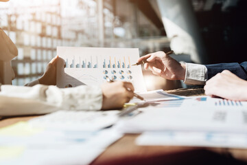 Wall Mural - A group of business people working together on a new project to analyze budgets and manage investment risks in today's profit boosting for marketing in the conference room