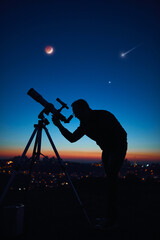 Wall Mural - silhouette of a man and telescope under the starry skies.