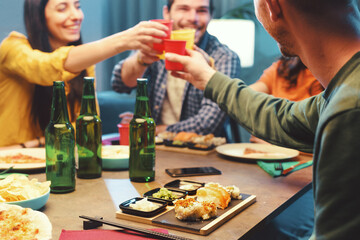 Friends eating and toasting together