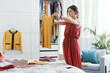 © StockPhotoPro - Woman choosing clothes in her bedroom