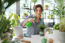 Woman Taking Care Of Plants At Home