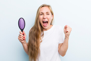 pretty blonde young adult woman with a hair comb