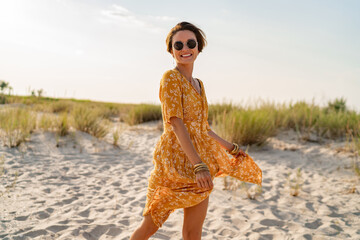 stylish attractive slim smiling woman on beach in summer style fashion trend outfit