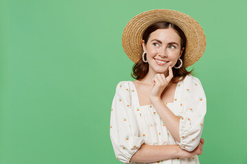 Wall Mural - Young happy smiling minded woman she 20s in white dress hat look aside on workspace area mock up prop up face isolated on plain pastel light green background studio portrait. People lifestyle concept.