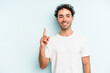© Asier - Young caucasian man isolated on blue background showing number one with finger.