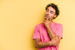 © Asier - Young caucasian man isolated on yellow background looking sideways with doubtful and skeptical expression.