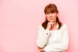 Middle age caucasian woman isolated on pink background looking sideways with doubtful and skeptical expression.