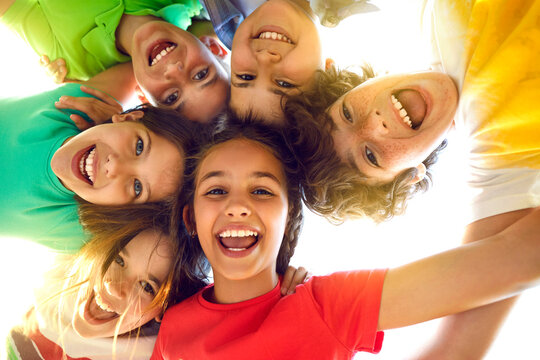 bunch of cheerful joyful cute little children playing together and having fun. group portrait of hap