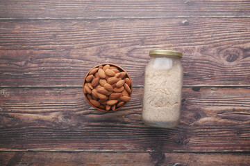 almond powder and almond in a jar on table,