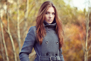 Wall Mural - Portrait of young beautiful woman in autumn coat. Fashion photo