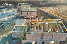 Aerial View Of Residential Houses Under Construction In Rural Suburban Area. Real Estate Development