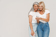 © Drobot Dean - Mature multiracial women smiling and holding cellphones