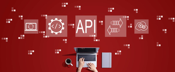 API - application programming interface concept with person working with a laptop