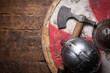 Old battle swords, axe and shield on the wooden table flat lay background with copy space.
