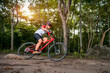 © VStudio - Mountain bikers ride MTB, mountain bike downhill to the extreme. Asian man rides MTB, mountain bike downhill in the wild to extremes. Extreme Sport and MTB, mountain bike downhill Concept.