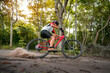 © VStudio - Mountain bikers ride MTB, mountain bike downhill to the extreme. Asian man rides MTB, mountain bike downhill in the wild to extremes. Extreme Sport and MTB, mountain bike downhill Concept.