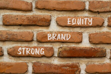 Strong Brand Equity Symbol. Concept Words Strong Brand Equity On Red Bricks On A Beautiful Brick Wall Background. Business, Finacial And Strong Brand Equity Concept. Copy Space.