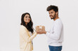 © Drobot Dean - East asian young man and woman smiling and posing with gift box