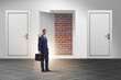 © Elnur - Businessman facing no exit with brick door