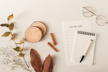 Travel concept. Composition with eyeglasses, to do list, dried leaves, pen and notepad on a white background. Autumn, fall mock up. Flat lay, top view.