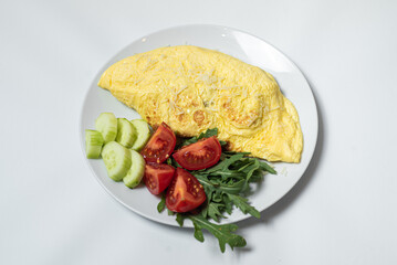 Canvas Print - Vegetable egg omelette on a plate. Vegetarian omelet with fried red pepper, fresh parsley and spices. Fork, knife on a burlap and on white background. Breakfast recipe