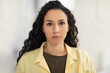 © Prostock-studio - Portrait of focused young Latin woman in casual clothes looking at camera at home