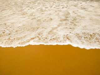 Wall Mural - Clear beach and golden sand with beautiful waves are used as a background for the designs.