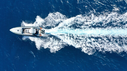 Wall Mural - Aerial drone photo of luxury rigid inflatable speed boat cruising in high speed in Aegean deep blue sea, Greece