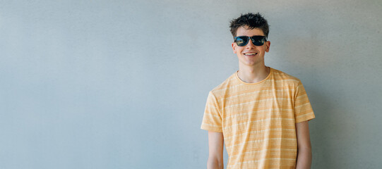 Poster - isolated teen boy with sunglasses